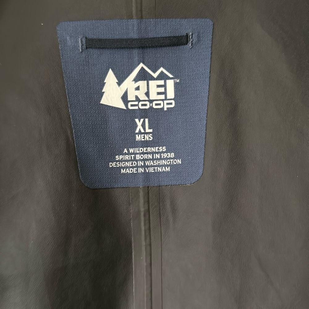 REI XL rain coat with hood. Pockets zipper. Blue/navy color rarely worn